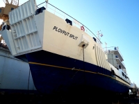 Docks Occupied by a Catamaran, a Yacht and a Repair Ship